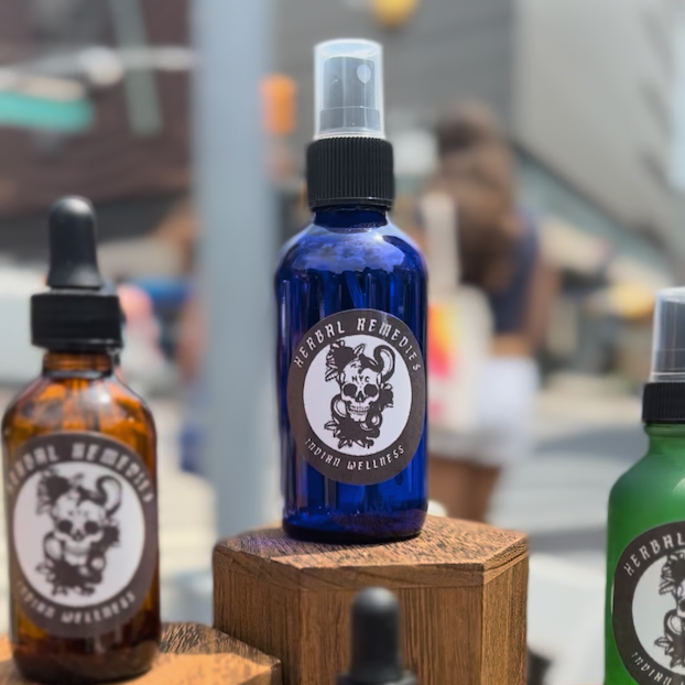 One 2 oz bottle with label on wooden stands in a store setting